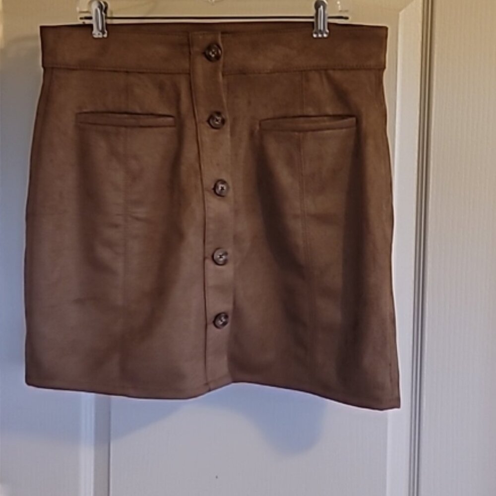 Brown skir suede-like feel. 93% polyester 7% spandex